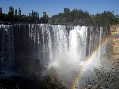 waterfalls and rainbow during daytime thumbnail