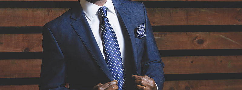 person wearing blue suit jacket with matching necktie and white dress shirt thumbnail