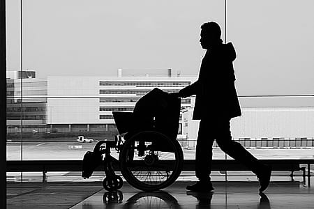 silhouette of man holding wheelchair thumbnail