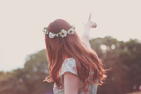 woman pointing on sky in selective focus photography thumbnail