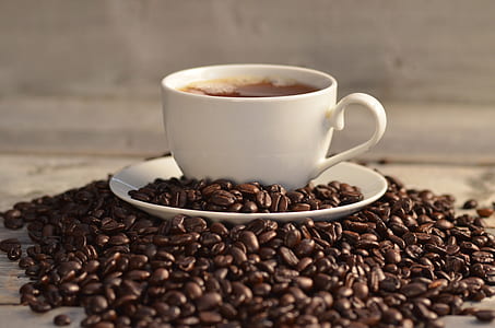 white mug surrounded by coffee beans thumbnail