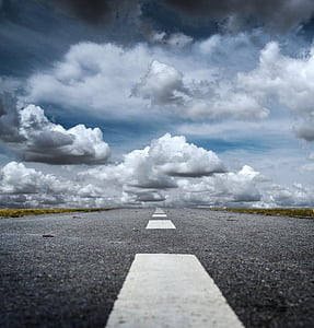 low angle photography of pathway under clouds thumbnail