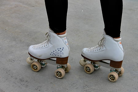 person wearing pair of white roller skates thumbnail