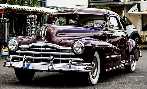 vintage black car on pavement thumbnail