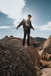 man standing on top of brown sand thumbnail