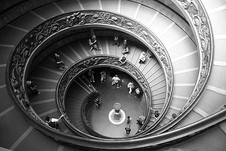 gray scale photography of group of people in twirl staircase thumbnail