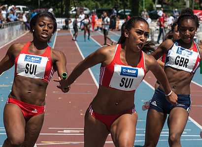 women running and passing baton thumbnail
