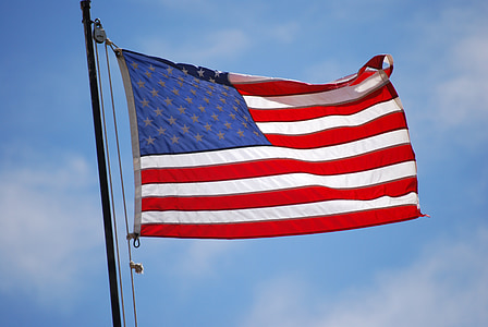 waving U.S.A flag with pole at daytime thumbnail