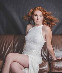 woman sitting on brown leather sofa thumbnail