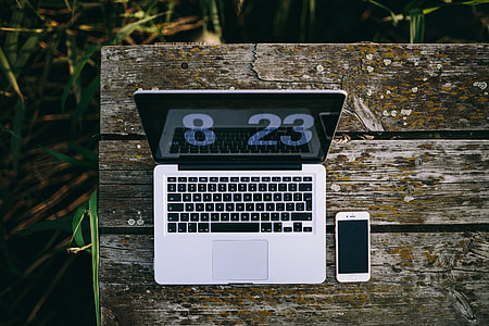 Man working on Macbook at lake thumbnail