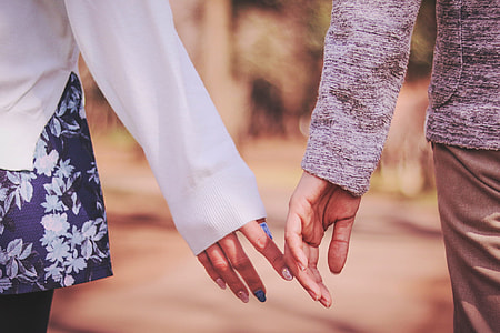 two persons wearing long-sleeved top touching hands thumbnail