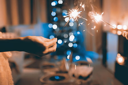 Hands of people holding Bengal light at the party thumbnail