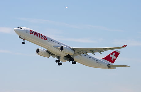 flying white Swiss airplane during daytime thumbnail