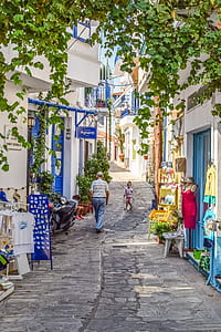 man walking on village during daytime thumbnail