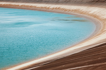 dam filled with blue water thumbnail