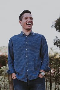 man in blue button-up long-sleeved shirt laughing during daytime thumbnail