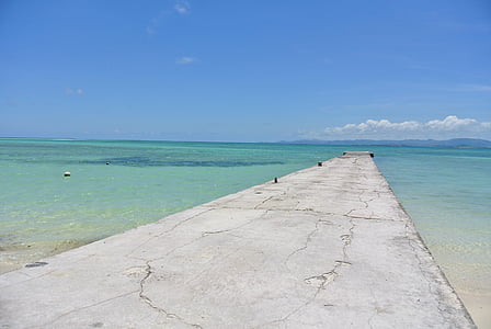 gray concrete dock and sea at daytime thumbnail