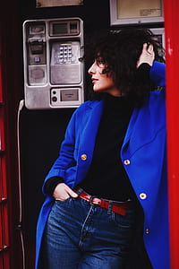woman leaning on telephone booth thumbnail