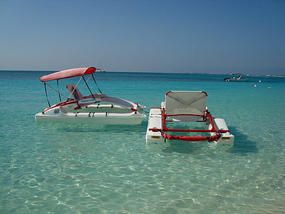 white pedal boats on body of water thumbnail