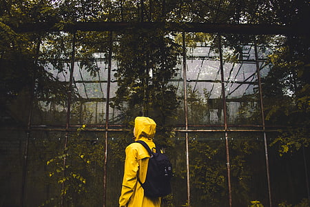 person in yellow top and black backpack thumbnail