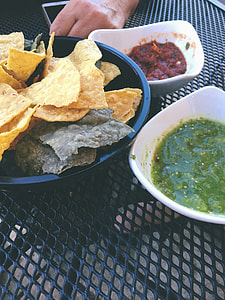 nachos on black plate near dips thumbnail