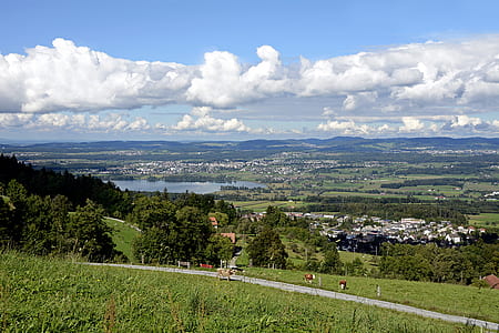 green valley under white and blue sky thumbnail