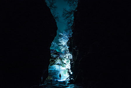 person standing between mountains during nighttime thumbnail