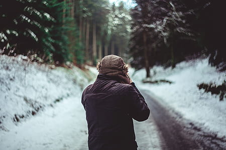 man walking on snowy path thumbnail