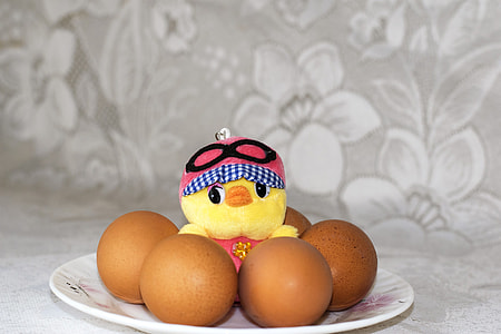 four brown organic eggs on plate thumbnail