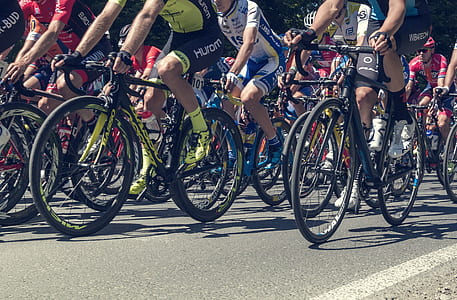 people riding bicycles on road during daytime thumbnail