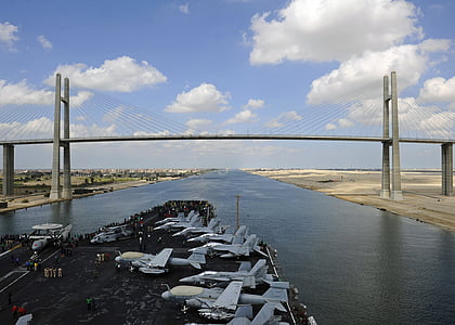 aerial photography of ship carrying planes under blue sky thumbnail
