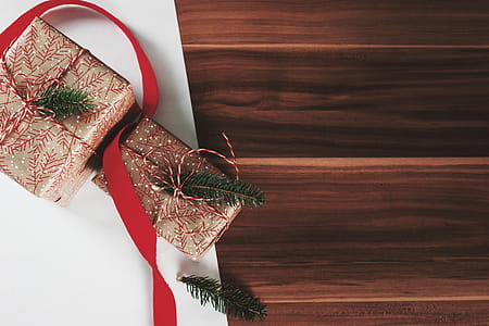Christmas presents laid on a wooden table background thumbnail