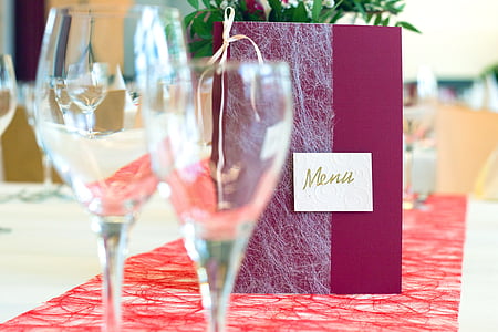 two clear footed wine glasses on table thumbnail