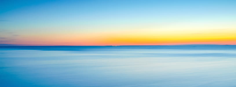 blue ocean during sunrise thumbnail