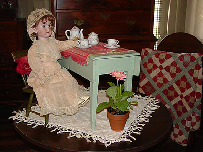 girl doll on brown wooden table thumbnail