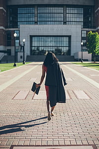 woman walking towards University of Alabama building thumbnail