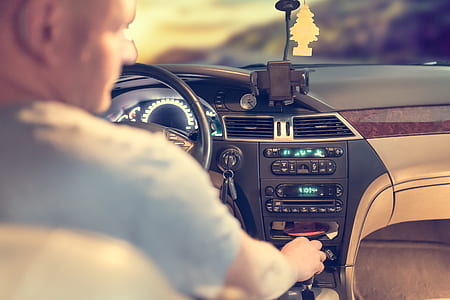 man driving his car while switching the music thumbnail