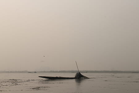 wrecked boat sink in the middle of body of water thumbnail