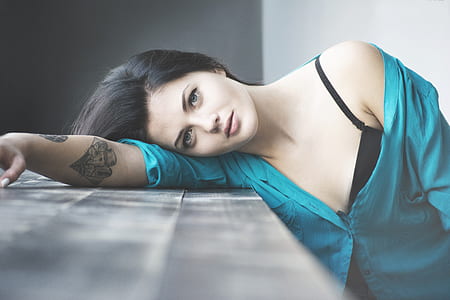woman leaning on gray wooden surface thumbnail