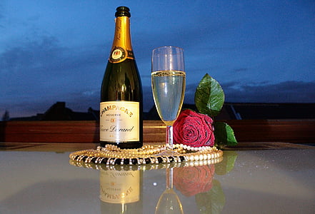 white and brown labeled champagne bottle on white surface thumbnail
