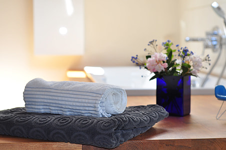 white textile on brown bathroom towel thumbnail