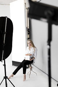 Woman Sitting on Stool While Holding Box thumbnail