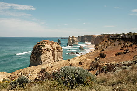 rock formation near body of water at daytime thumbnail