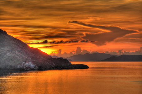 photo of mountain under white and blue sky at sunset thumbnail