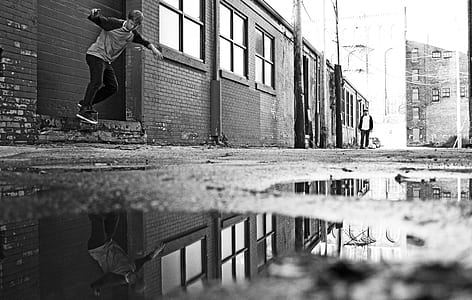 grayscale photography of boy flip his skateboard thumbnail