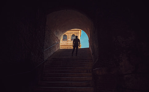 silhouette of person standing on stairs during daytime thumbnail