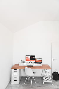 black flat screen computer monitor on top of brown and white single-pedestal desk thumbnail