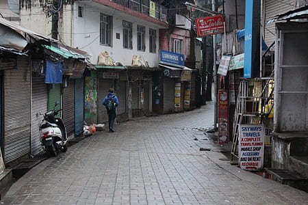 person walking in the alley during daytime thumbnail