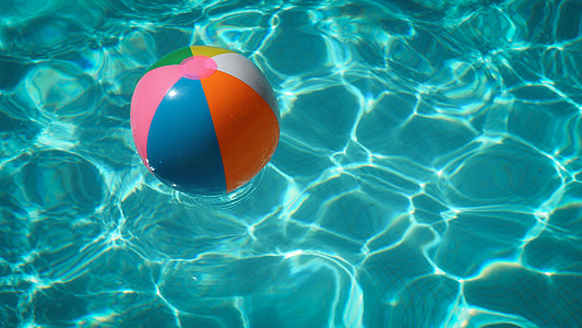 blue, pink, and orange inflatable ball on body of water thumbnail