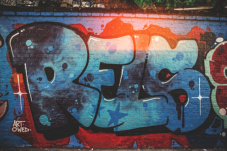 A brick wall covered in graffiti thumbnail